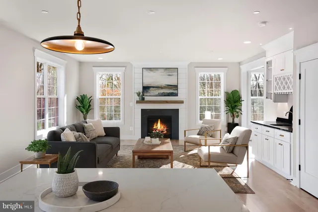 a living room with furniture a fireplace and a large window