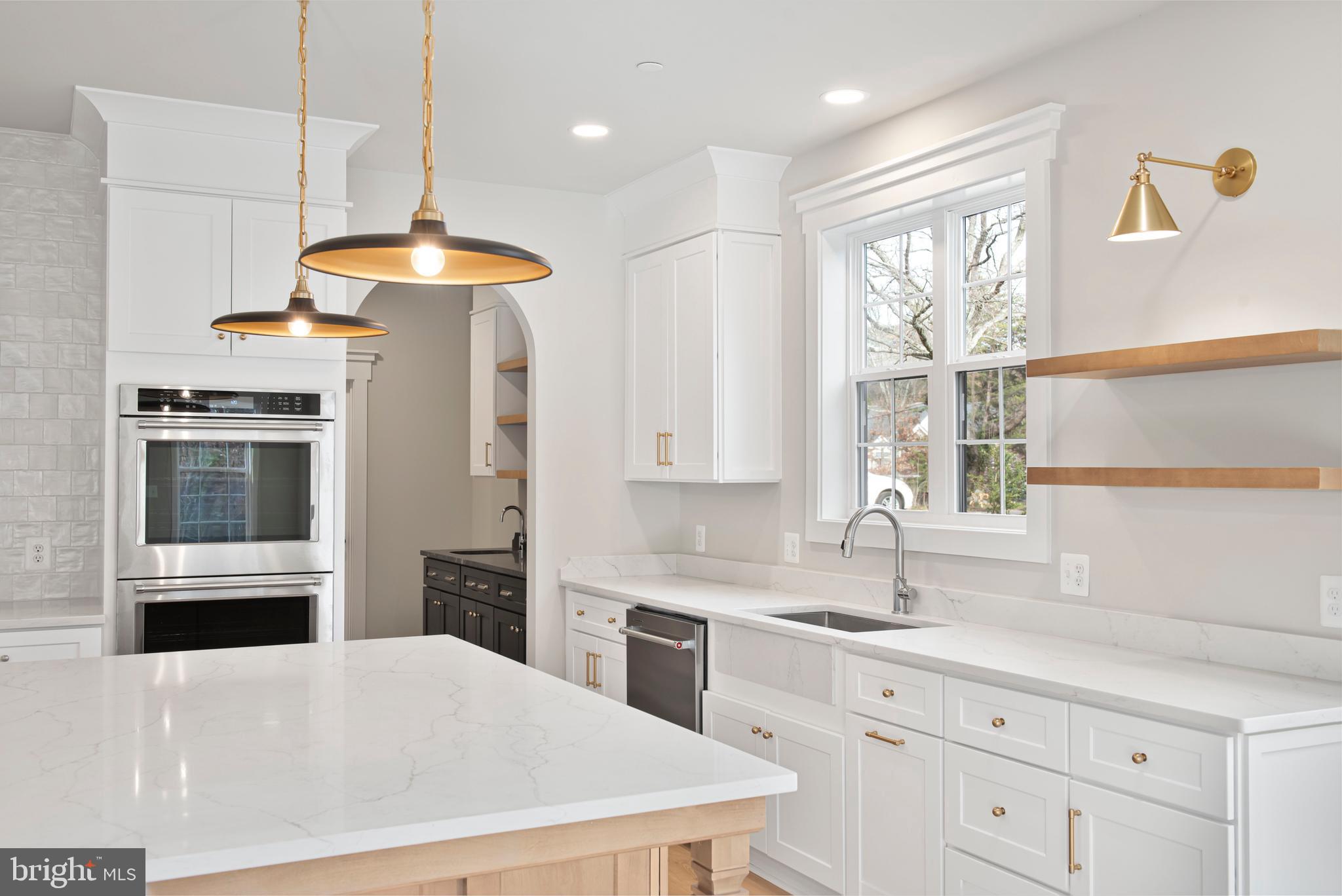 17 Vinter Lane Pasadena, MD 21122 - Photo 4 of 40 a kitchen with stainless steel appliances a stove a sink a refrigerator and windows