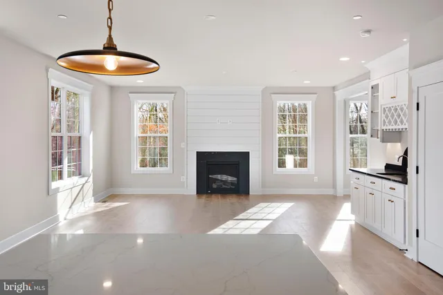 a view of an empty room with a fireplace and a window
