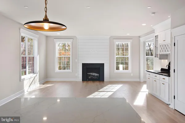 a view of an empty room with a fireplace and a window