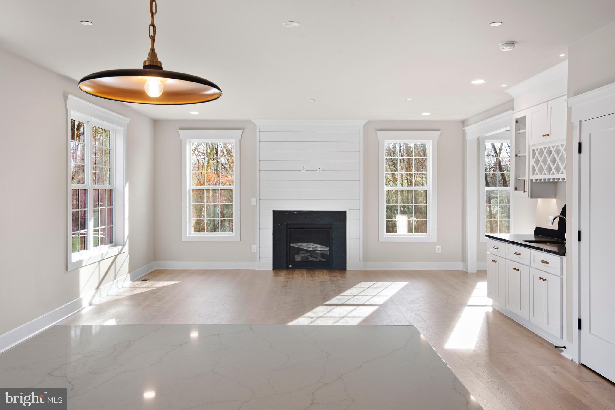 17 Vinter Lane Pasadena, MD 21122 - Photo 6 of 40 a view of an empty room with a fireplace and a window