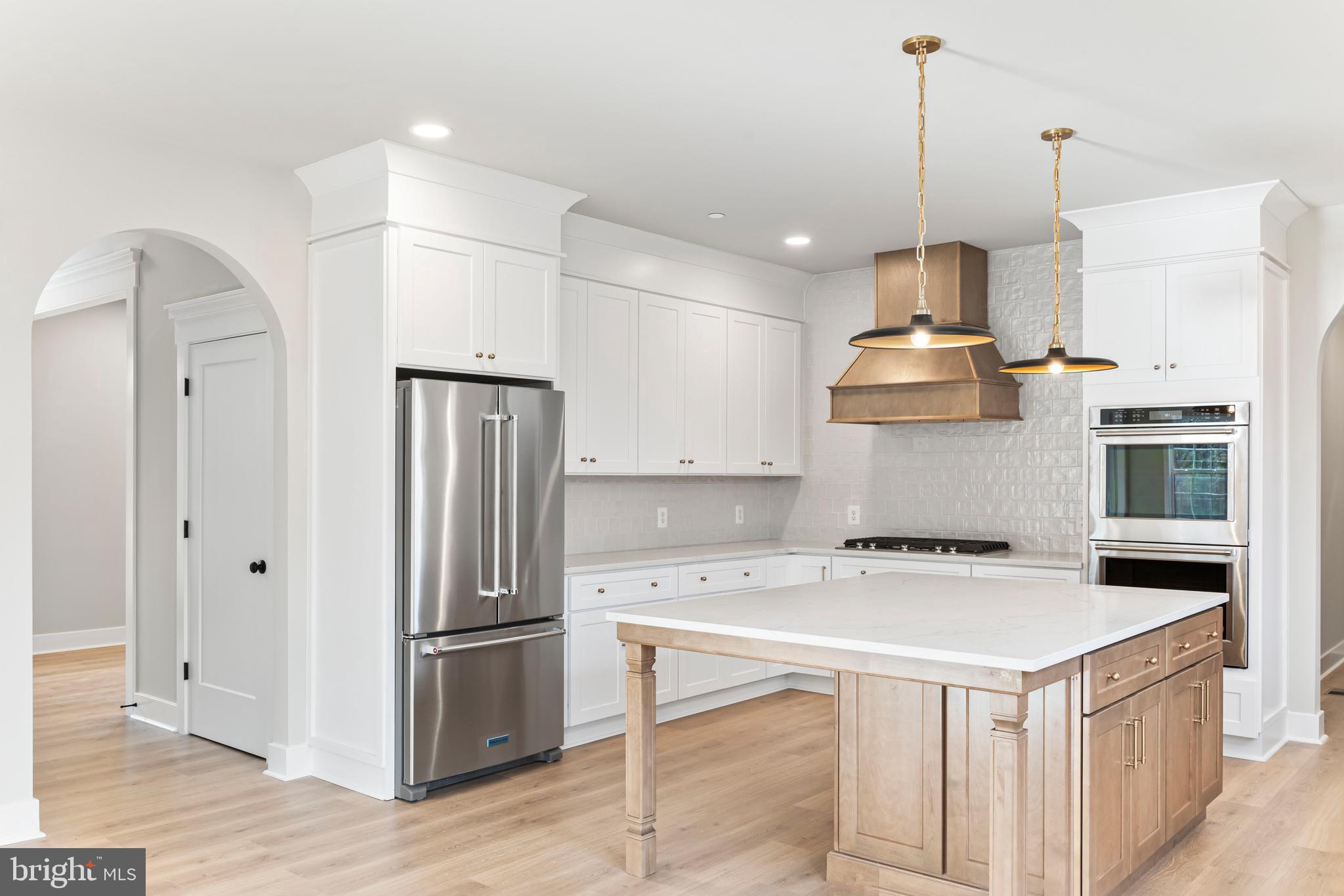 17 Vinter Lane Pasadena, MD 21122 - Photo 7 of 39 a kitchen with a refrigerator a sink and wooden floor