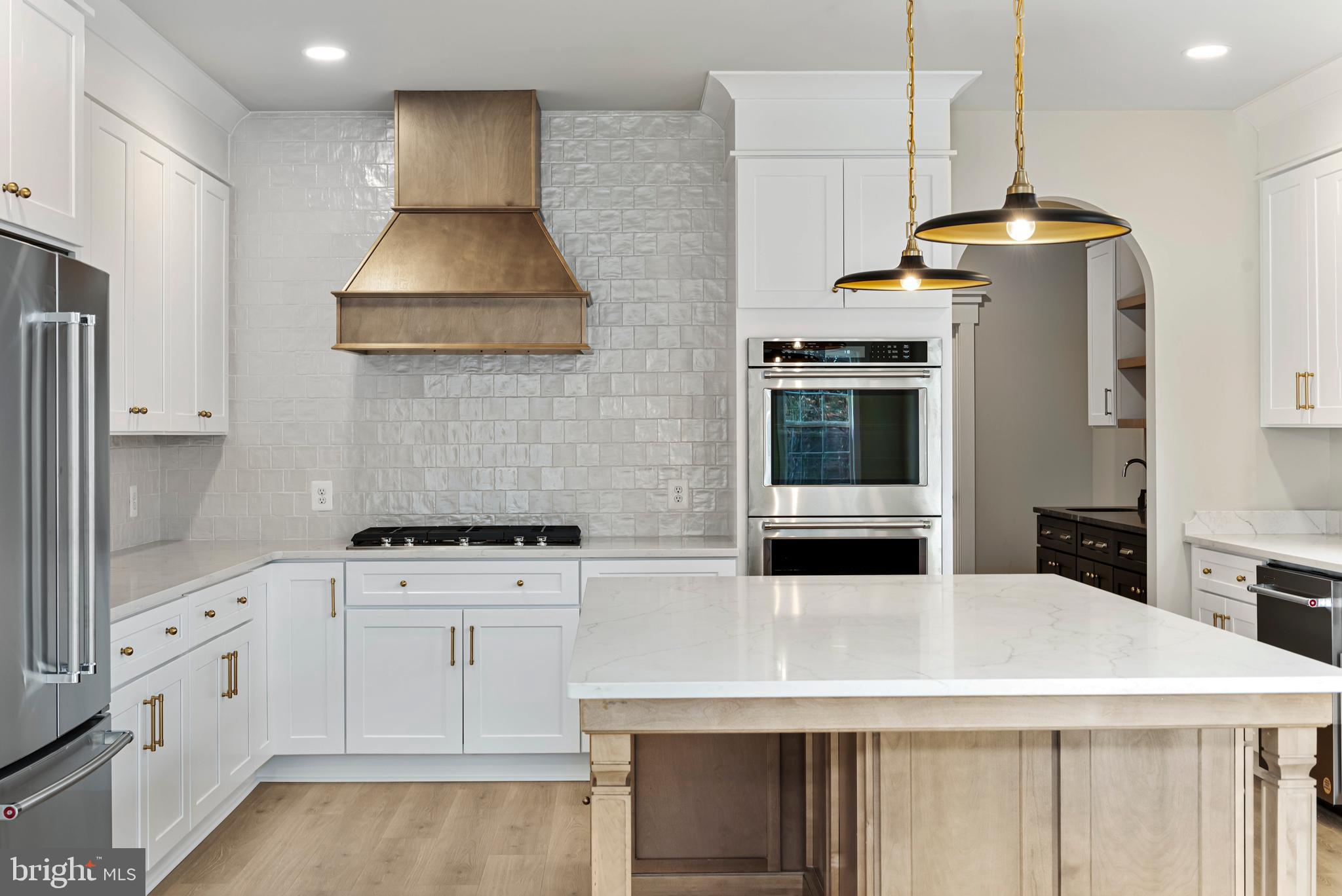 17 Vinter Lane Pasadena, MD 21122 - Photo 8 of 39 a kitchen with stainless steel appliances granite countertop a stove and a refrigerator