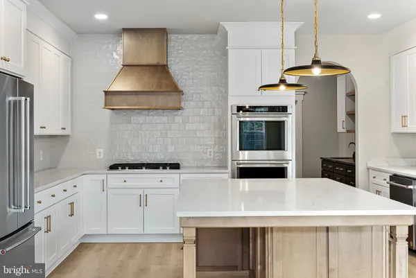 a kitchen with stainless steel appliances granite countertop a stove and a refrigerator