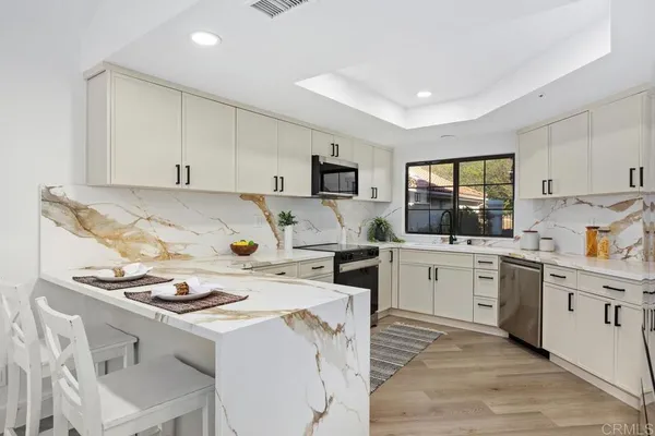a kitchen with a stove a sink and a refrigerator