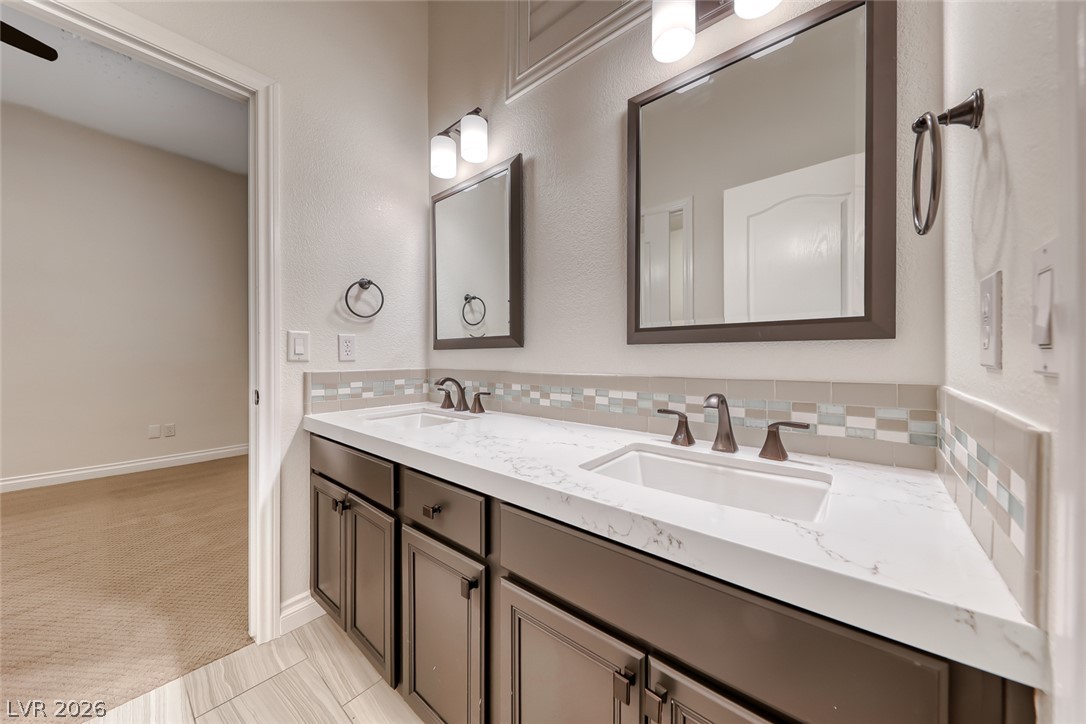 2122 Mooreview Street Henderson, NV 89012 - Photo 30 of 44 Dual vanity with elegant finishes and a stylish tile backsplash define this bath.