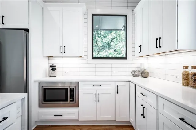 a kitchen with a sink and a potted plant
