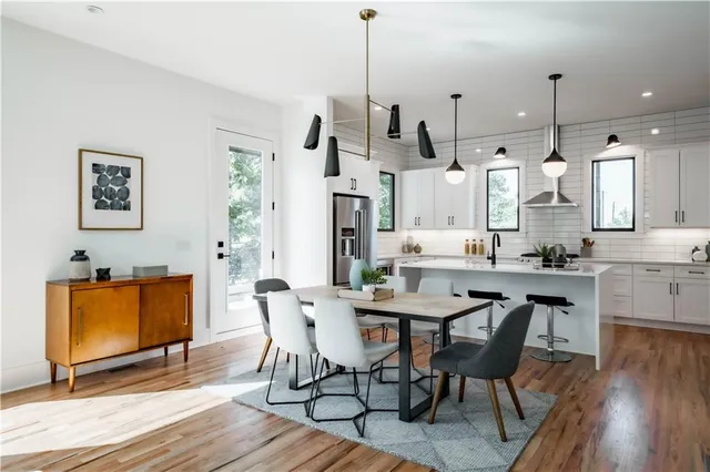 a large white couch sitting in a living room next to a window