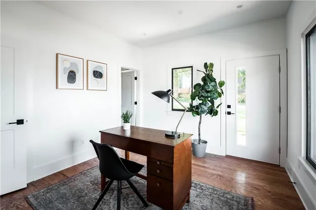 a bathroom with a granite countertop toilet sink and mirror