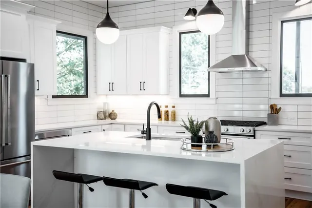 a kitchen with white cabinets and a sink