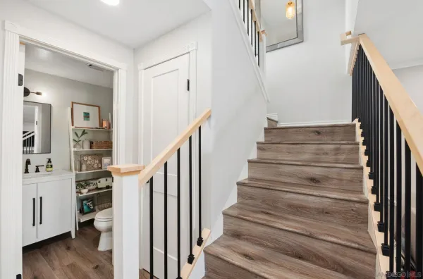 a view of entryway and hall with wooden floor