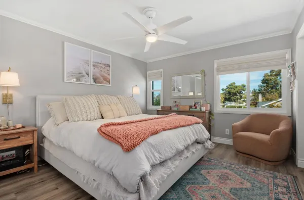 a spacious bedroom with a bed and a couch