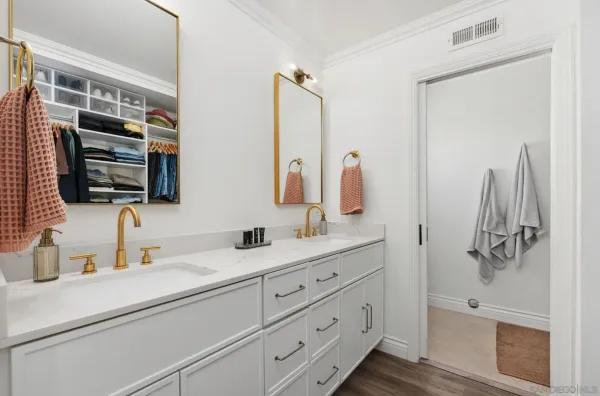 a bathroom with a double vanity sink mirror and shower
