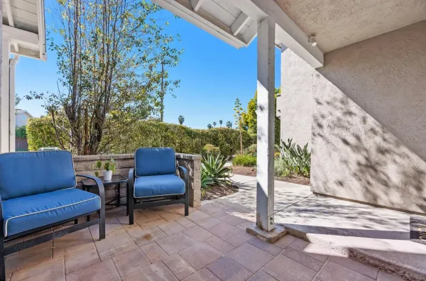 a outdoor sitting area with benches and garden view
