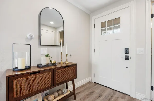 a very nice looking room with wooden floor and cabinets