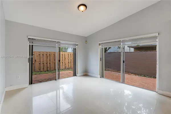 a view of an empty room with glass door