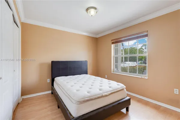 a bedroom with a bed and window