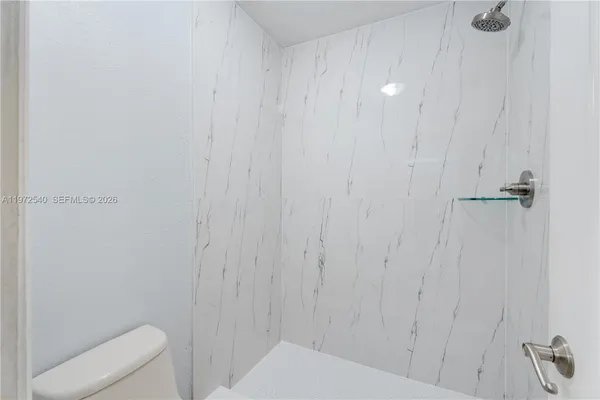 a bathroom with a shower and toilet