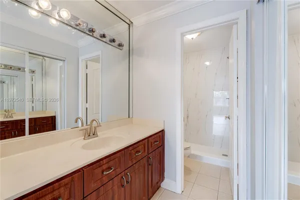 a bathroom with a shower sink vanity and mirror