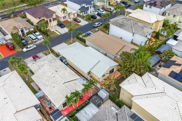 an aerial view of a house with a yard and potted plants
