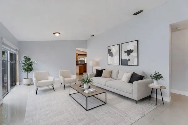 a living room with furniture and a potted plant