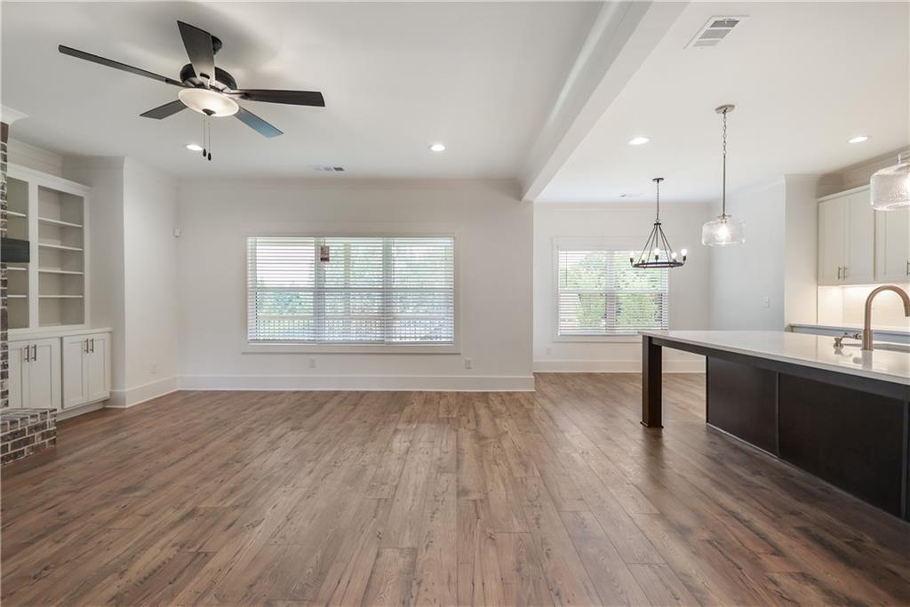 2113 Stonegate Way Monroe, GA 30656 - Photo 22 of 43 an empty room with wooden floor and windows
