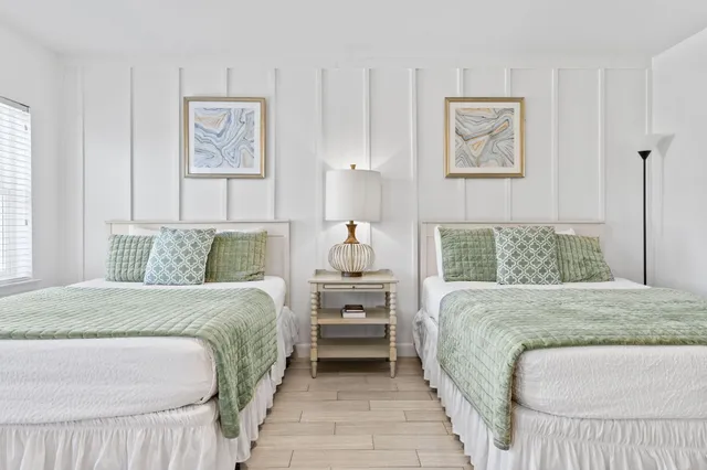 a bedroom with a bed and wall painting