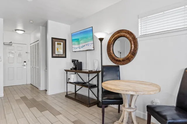 a view of a room with furniture and wooden floor