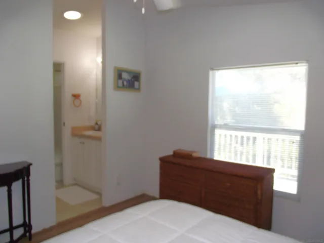 a room with a window and a ceiling fan