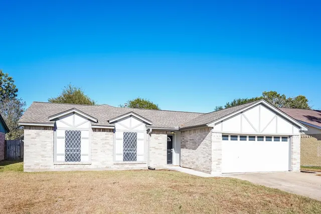 a view of a house with a wooden fence