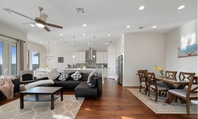 344 Pisa Lane Georgetown, TX 78628 - Photo 11 of 39 Gleaming hardwood floors and recessed lighting enhance this airy, open-concept living space.