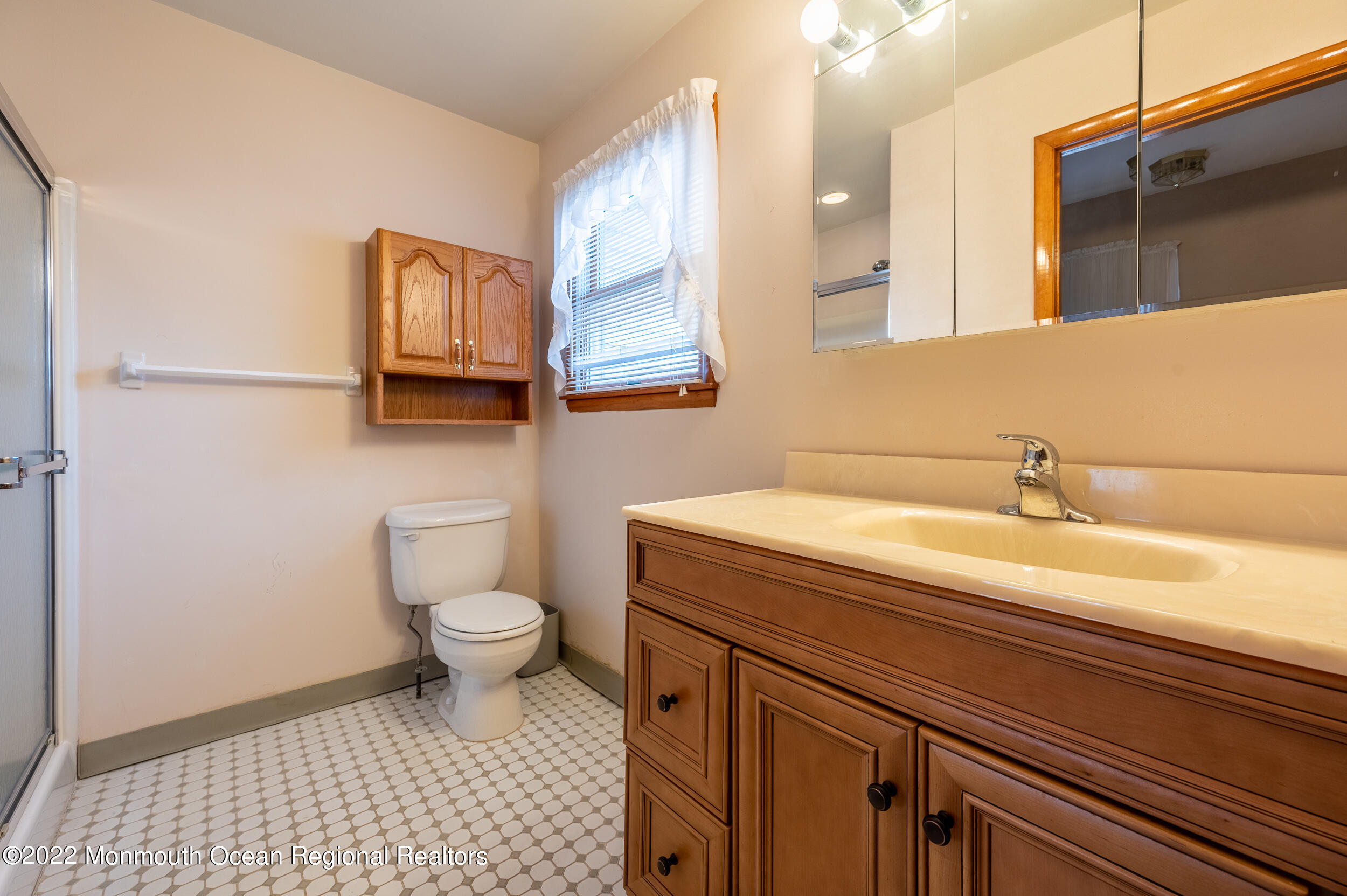 23 Neptune Road Toms River, NJ 08753 - Photo 21 of 36 a bathroom with a sink a toilet and mirror