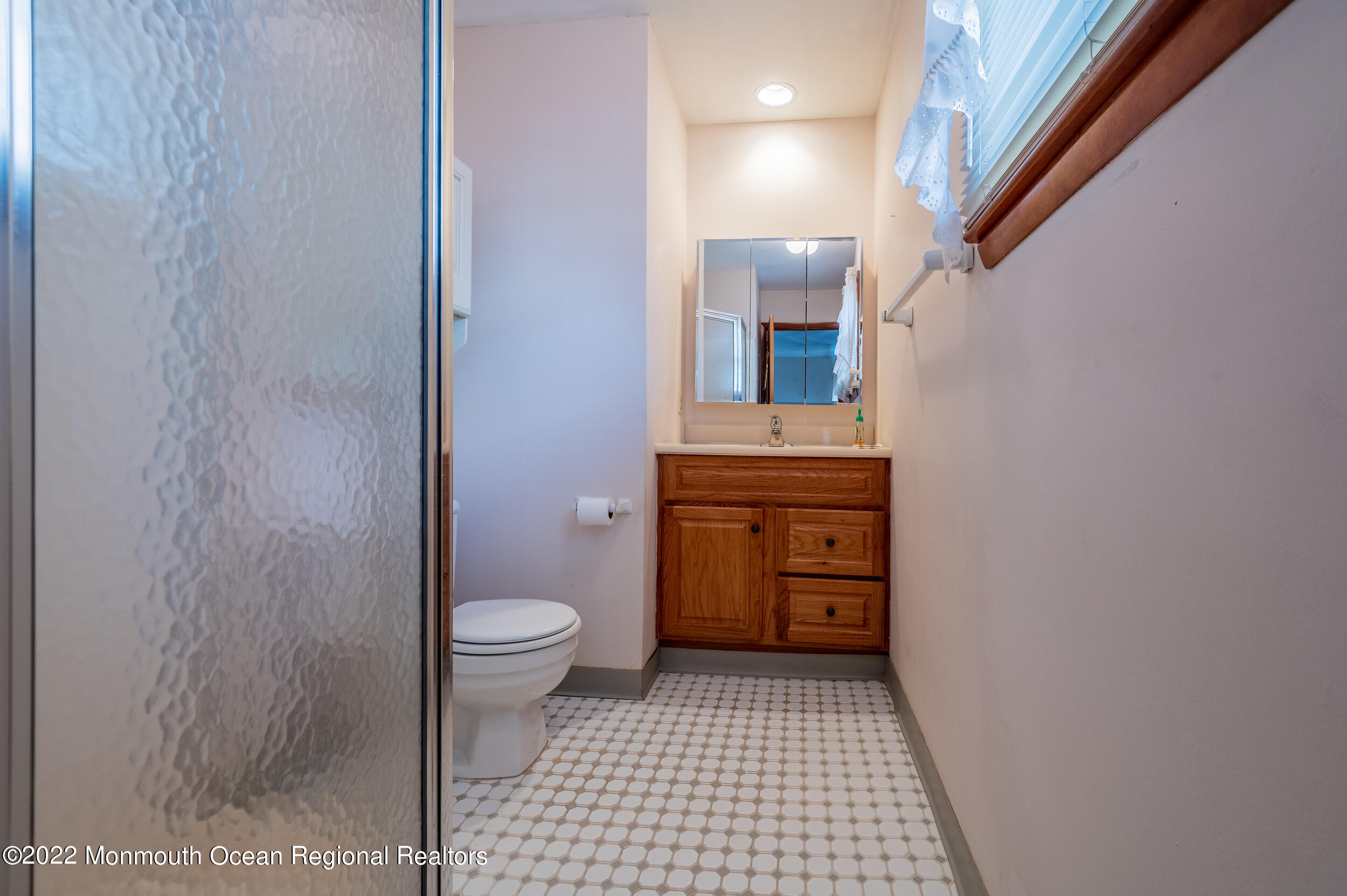 23 Neptune Road Toms River, NJ 08753 - Photo 23 of 36 a bathroom with a sink a toilet and a mirror