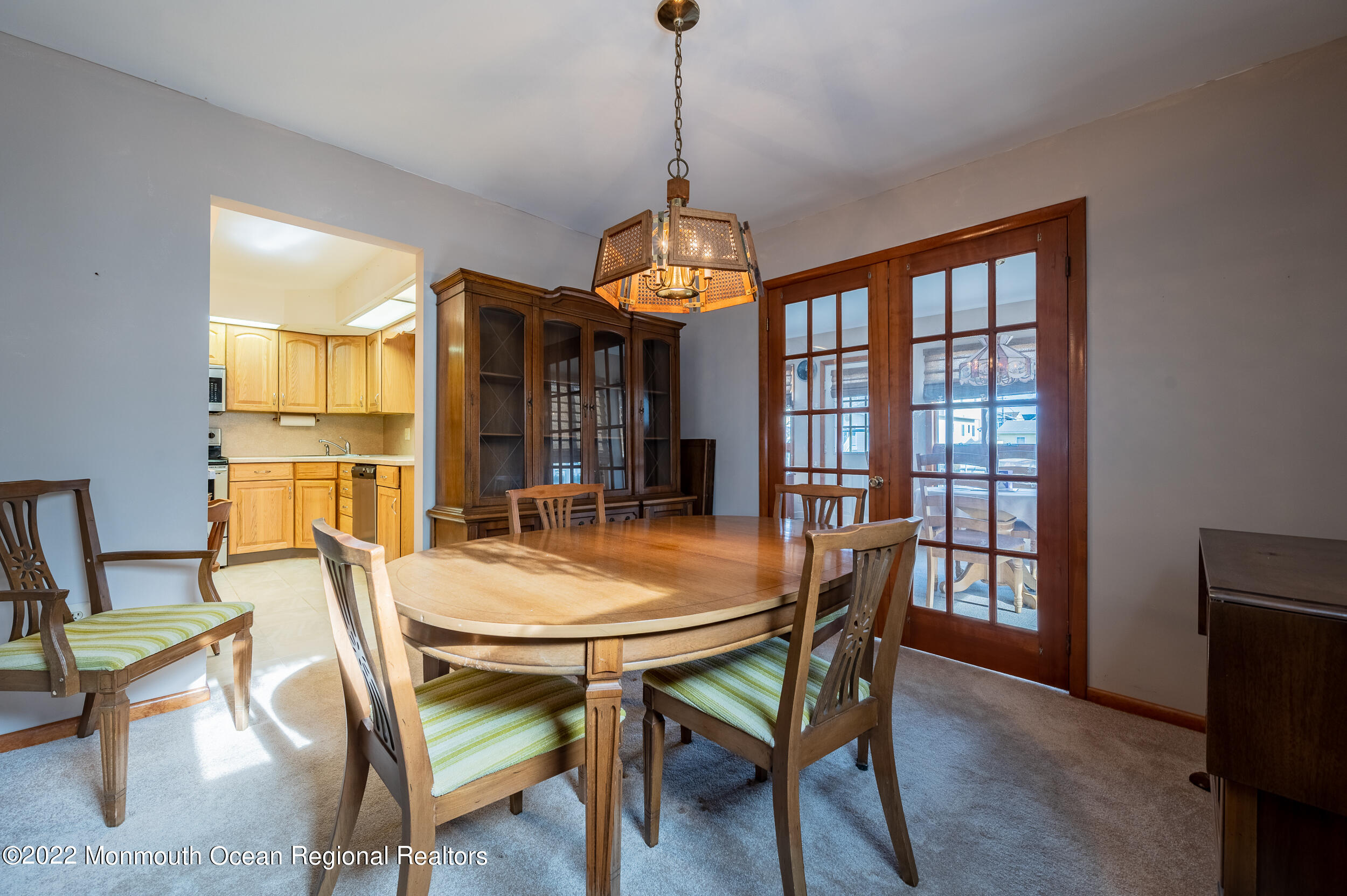 23 Neptune Road Toms River, NJ 08753 - Photo 9 of 36 a dining room with wooden floor a chandelier a wooden table and chairs