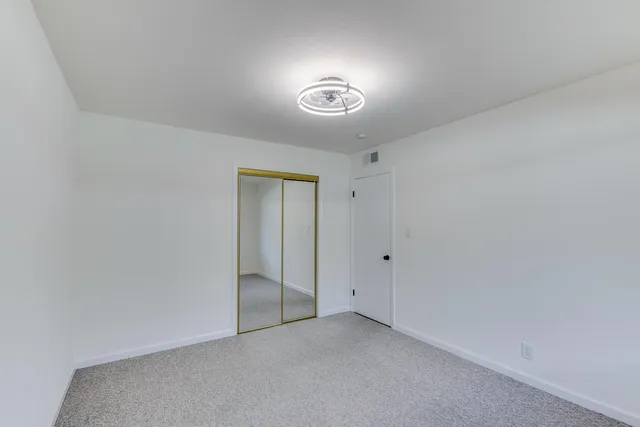 a view of an empty room and a window