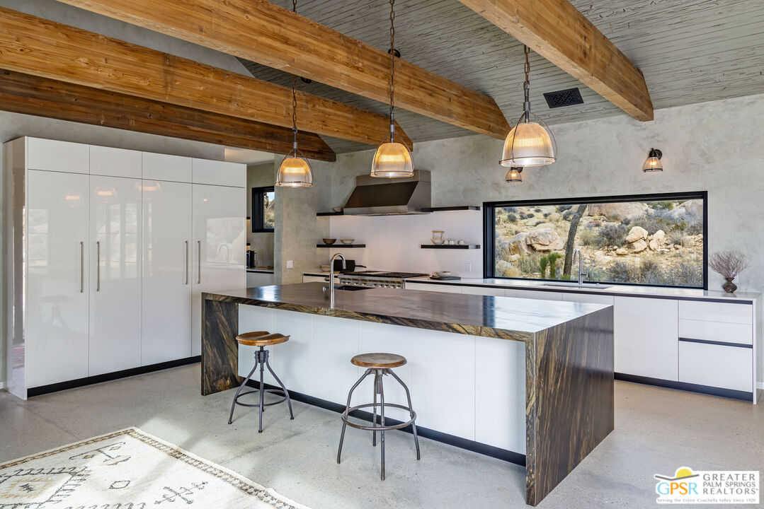 1653 Roadrunner Rut Pioneertown, CA 92268 - Photo 14 of 60 a kitchen with stainless steel appliances granite countertop a sink and wooden floors