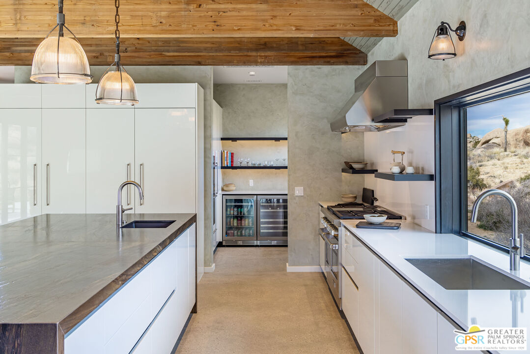 1653 Roadrunner Rut Pioneertown, CA 92268 - Photo 16 of 60 a kitchen with stainless steel appliances granite countertop a sink stove and cabinets