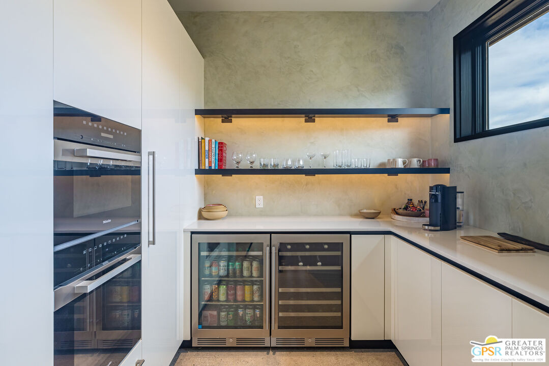 1653 Roadrunner Rut Pioneertown, CA 92268 - Photo 17 of 60 a kitchen with granite countertop a stove and a refrigerator