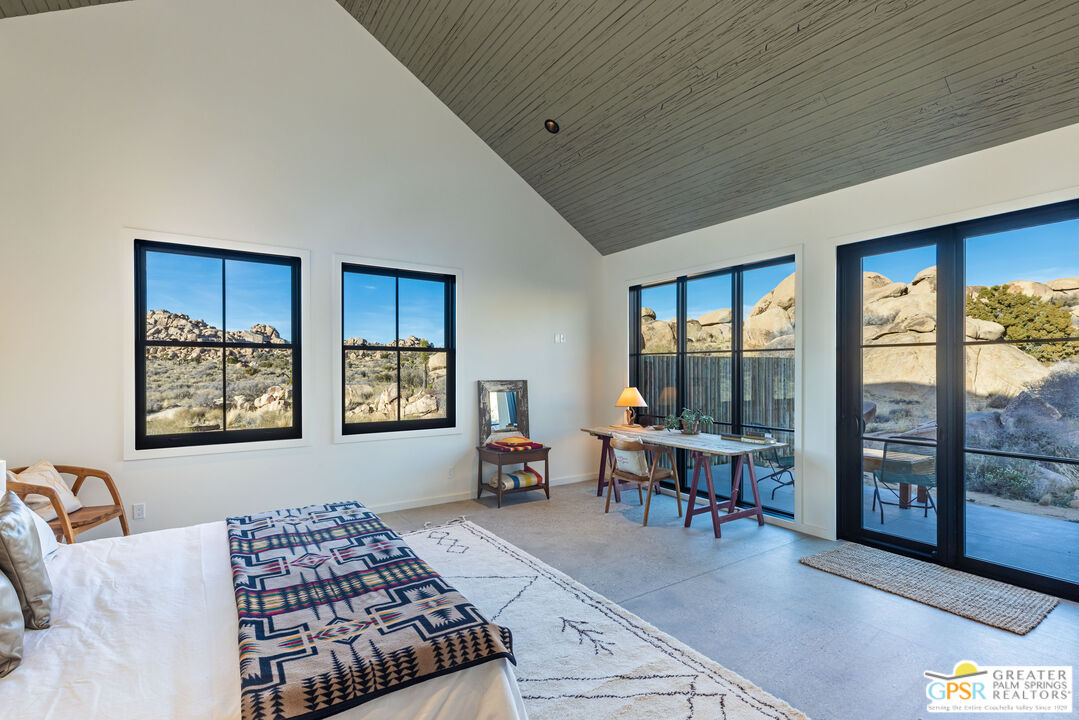 1653 Roadrunner Rut Pioneertown, CA 92268 - Photo 30 of 60 a bedroom with furniture and a large window