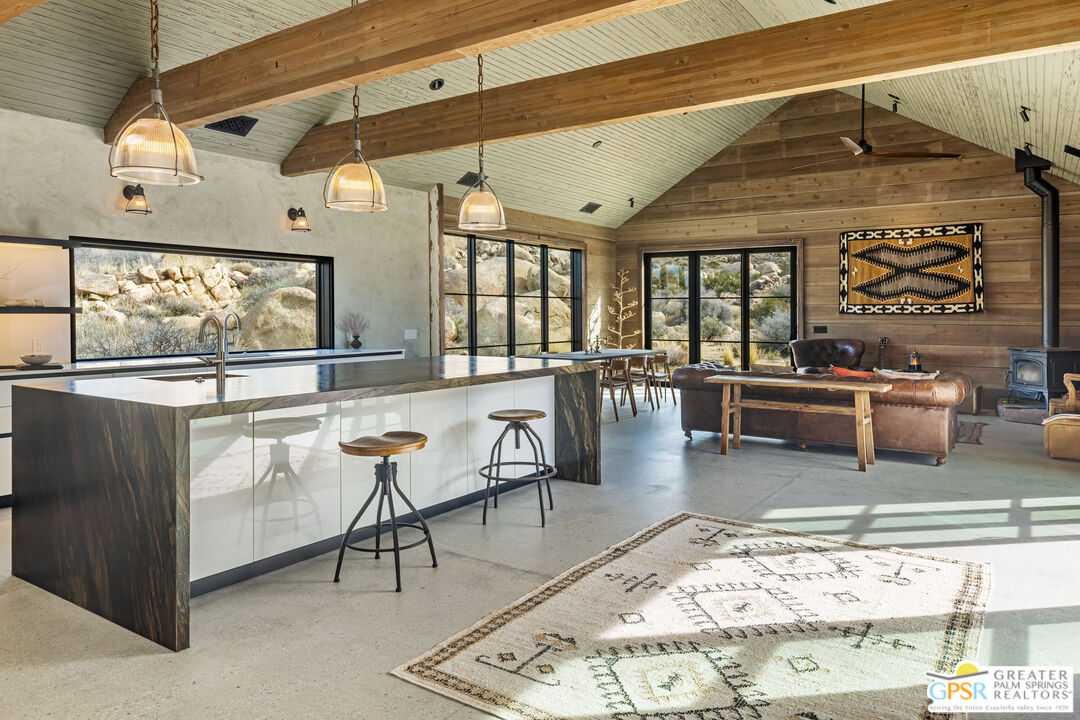 1653 Roadrunner Rut Pioneertown, CA 92268 - Photo 3 of 60 a living room with stainless steel appliances kitchen island granite countertop furniture and a rug