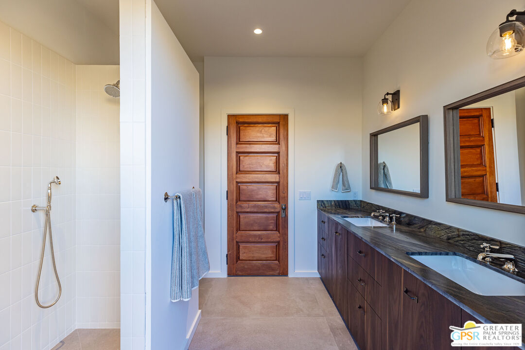 1653 Roadrunner Rut Pioneertown, CA 92268 - Photo 32 of 60 a bathroom with a granite countertop sink and a mirror