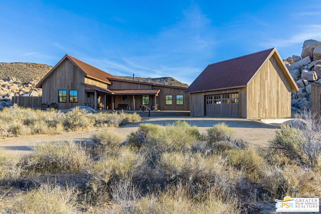 1653 Roadrunner Rut Pioneertown, CA 92268 - Photo 35 of 60 a front view of a house with a yard