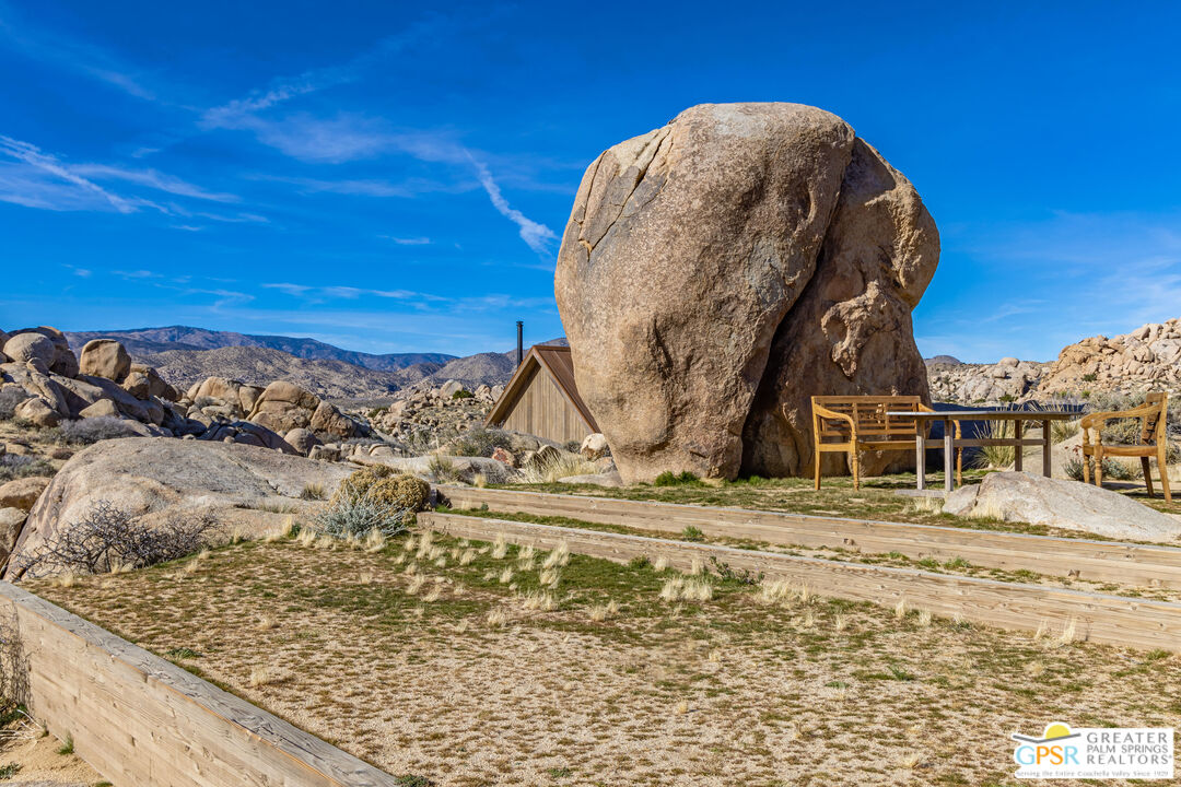 1653 Roadrunner Rut Pioneertown, CA 92268 - Photo 50 of 60 a view of a dry yard with wooden fence