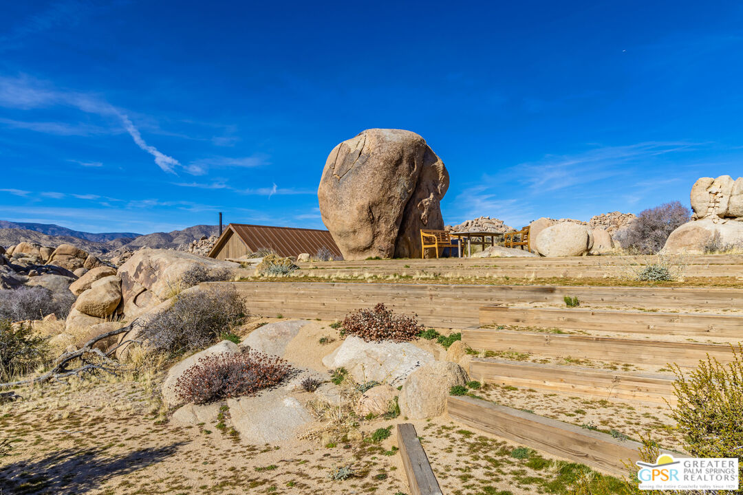 1653 Roadrunner Rut Pioneertown, CA 92268 - Photo 52 of 60 a view of a bedroom with a bed and a chair