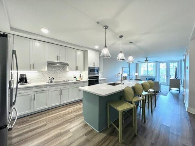 a large kitchen with kitchen island a dining table and chairs