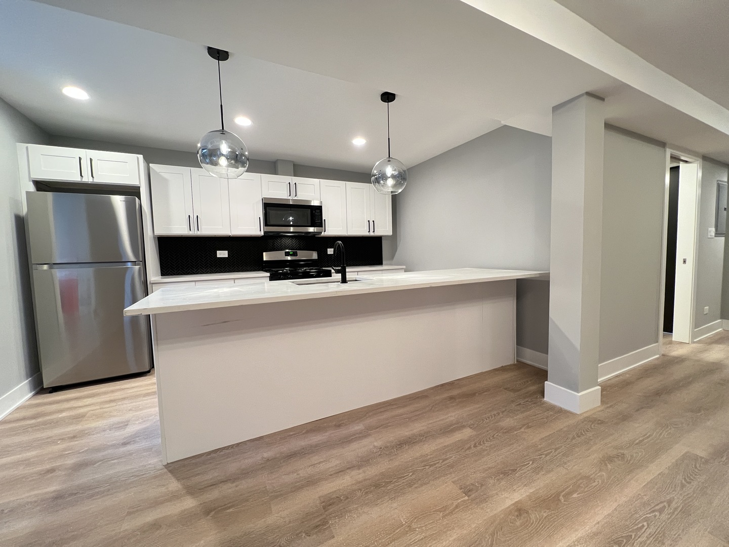 911 South Miller Street, Unit G Chicago, IL 60607 - Photo 2 of 11 a kitchen with stainless steel appliances a refrigerator sink and microwave