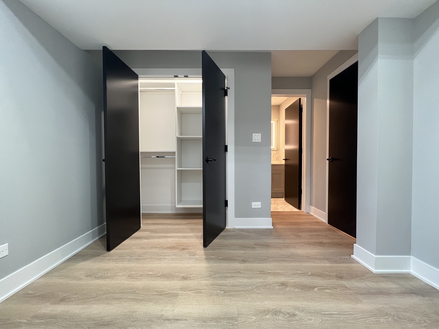 911 South Miller Street, Unit G Chicago, IL 60607 - Photo 10 of 11 a view of a hallway with wooden floor and closet
