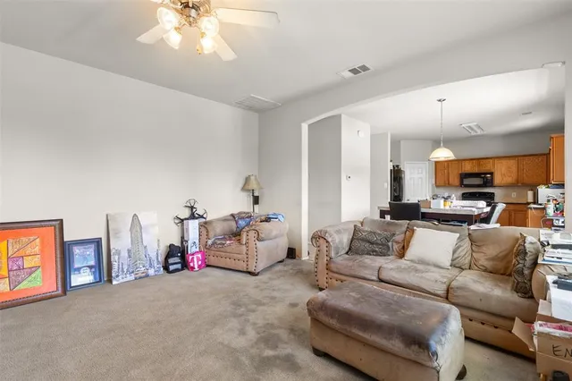 a living room with furniture and kitchen view