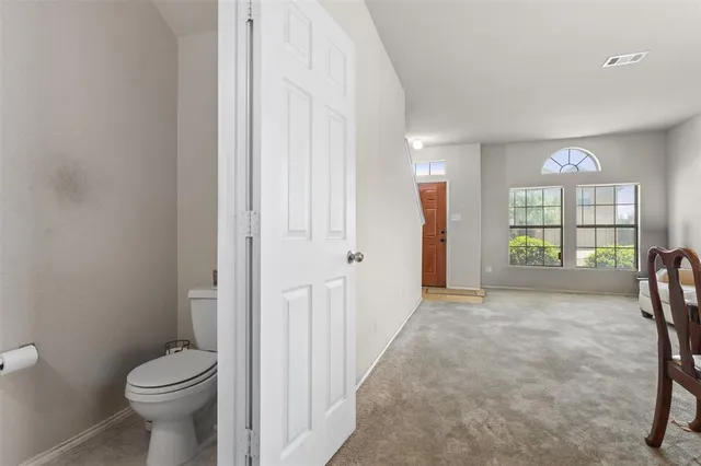 a view of a bathroom with a toilet and a shower