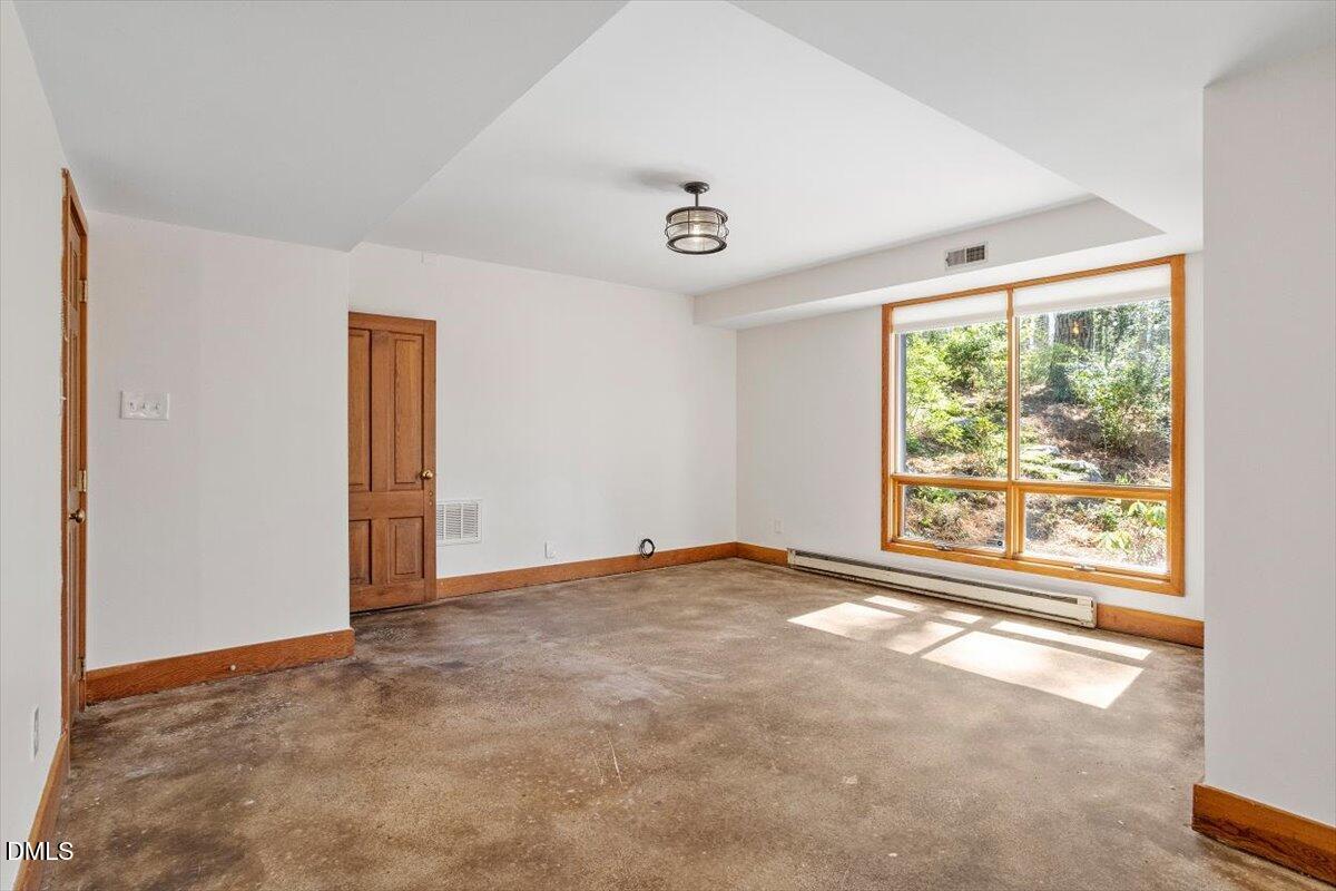 4805 Rembert Drive Raleigh, NC 27612 - Photo 32 of 45 an empty room with windows
